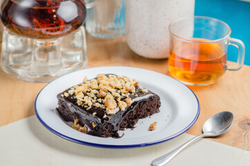Chocolate raw vegan cake brownies with nuts. Healthy raw food concept.