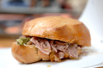 Lampredotto is the typical street food of the city of Florence in Tuscany and is a sandwich with a cow's stomach in a tomato sauce and put to stew
