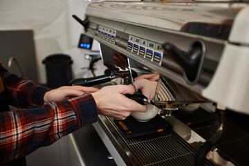 Barista using a coffee machine to make coffee