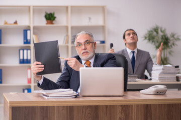 Two employees sitting at workplace