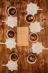 Close-up of a hodgepodge in a disposable paper cup. The concept of traditional food and foreign cuisine. Safe eco-friendly disposable tableware.