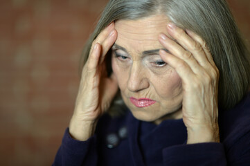 Close up portrait of sad ill senior woman