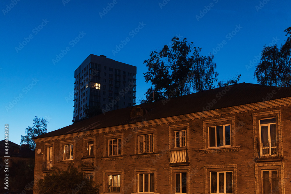 Wall mural the light burns in one window of the multitude in a multi-storey residential building