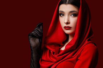 brunette woman with red lips and veil over her head