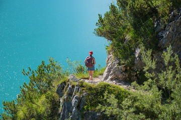 young woman walking along gaisalmsteig trail, lake achensee tirol austria
