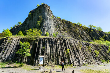 Hegyestu geological basalt cliff in kali basin hungary near Koveskal with a tourist woman