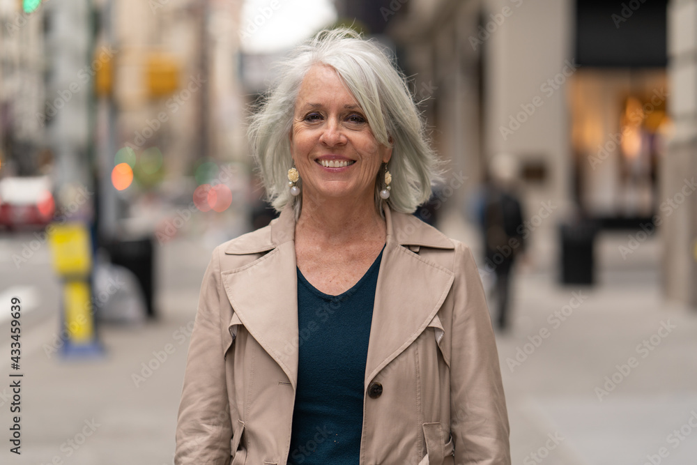 Wall mural mature caucasian woman in city smile happy face portrait