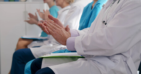 Doctors audience applauding after seminar for further education or training