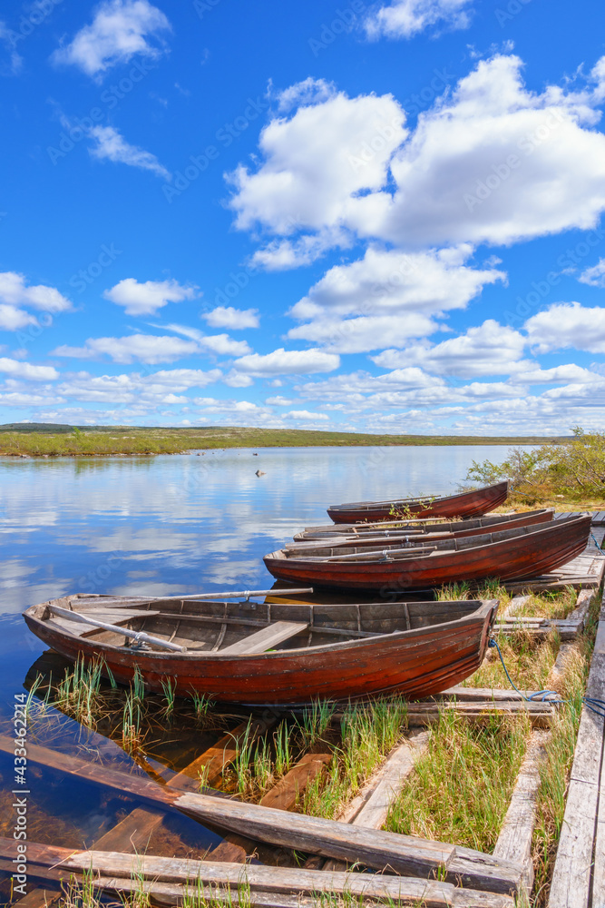 Sticker Rowing boats at a jetty in a lake at the highlands in the north