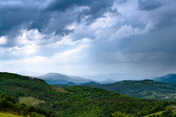 Green vivid mountains covered with threatening stormy clouds