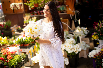 Young woman buying flowers at the flower market