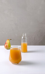 Pear drink in a glass on a white background. Natural healthy food concept with copy space