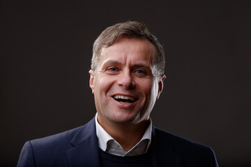 Professional stylish laughing middle-aged man studio portrait