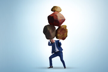 Businessman under burden in business concept