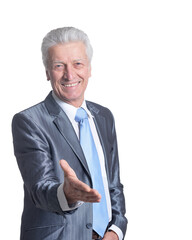 portrait of senior businessman wearing suit stretching out arm to shake hand