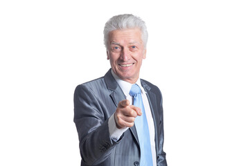 portrait of senior businessman wearing suit pointing to camera