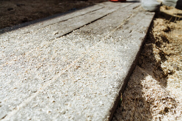 Sawdust on a board, timber and wood chips background