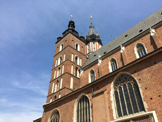 Fototapeta premium View of the St. Mary's Basilica, a Brick Gothic church adjacent to the Main Market Square in Kraków, Poland. It serves as one of the best examples of Polish Gothic architecture.