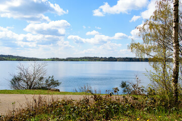 View on a lake with blue sky and clouds