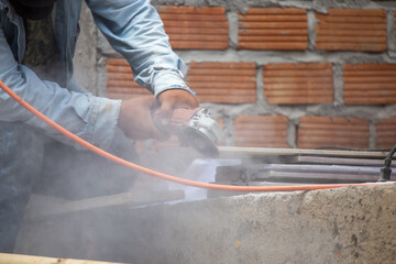 Construction workers are using cutting machines to cut through the cement.