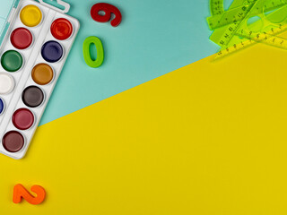 student's desk. Top view of the layout of school items. Rulers and numbers on a yellow and blue background. Back to school