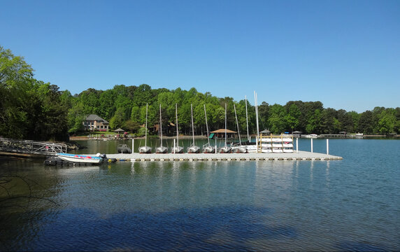 Boats docked at a pier in Lake Norman in Huntersville, North Carolina with homes in the background