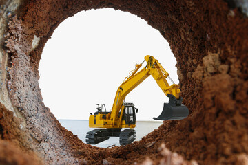 Crawler excavator are digging soil in the tunnel construction site. With a white background