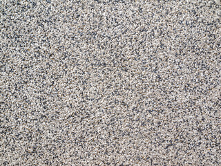 Grainy surface with tiny white black and gray rhinestones