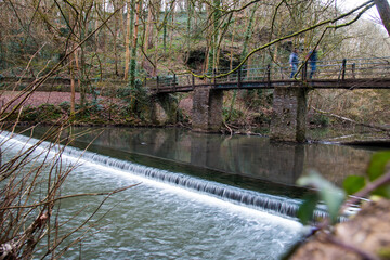 Bridge over a waterfall in Snuff Mills park, Bristol, UK © Zygimantas