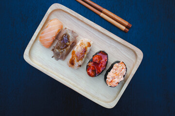 Zushi set is a Japanese dish that is placed on a wooden plate to add beauty to it even more.