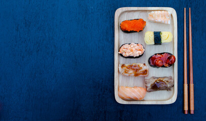 Zushi set is a Japanese dish that is placed on a wooden plate to add beauty to it even more.