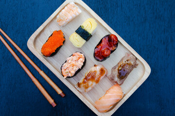 Zushi set is a Japanese dish that is placed on a wooden plate to add beauty to it even more.