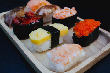 Zushi set is a Japanese dish that is placed on a wooden plate to add beauty to it even more.