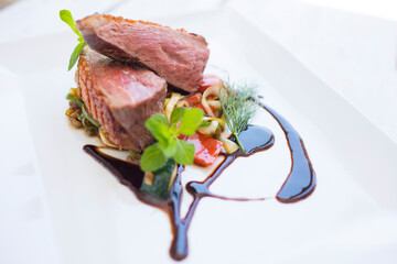 Grilled duck breast served on a plate in restaurant