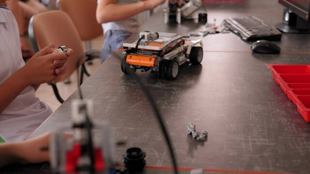 Close-up of a group of children playing with robots in a robotics school.