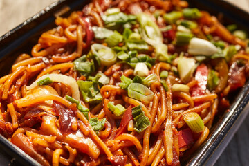 Hakka noodles, a classic Indian Chinese aka Desi Chinese dish packed in a takeout/takeaway container