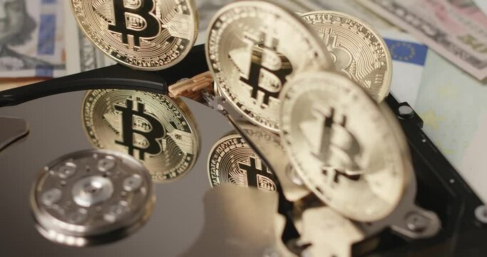 Bitcoin reflecting on HDD platter. Gold coin reflection on silver disk. Crypto currency technology concept
