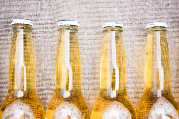 clear beers on jute background. summer.