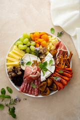 Charcuterie assortment, variety of cheeses and salami, prosciutto and dried fruits, figs, apricots,...