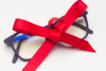 Black plastic glasses with a red bow