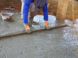Plasterers are using equipment to smooth the plaster.