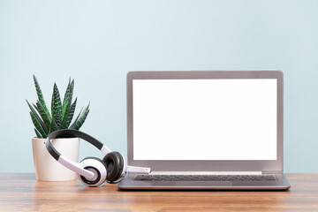 Laptop. Mockup blank screen and headphones on wooden desk. Distant learning. working from home, online courses or support minimal concept. Helpdesk or call center headset - obrazy, fototapety, plakaty