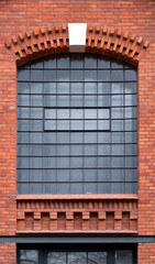 Architectural detail of glass block windows. 
Red brick wall after renovation. Architecture in...