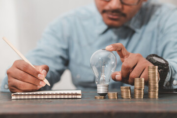 Business men display operational plans, analyze, process creative business strategies, symbolized by a light bulb that conveys the concept of energy, investment, finance.