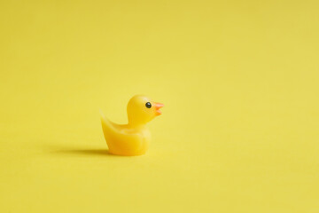 Yellow rubber ducks on yellow background - Minimal design