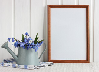 spring mockup with an empty frame and snowdrops.