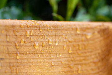 Treated wood, protected against moisture and water. Water drops after rain.