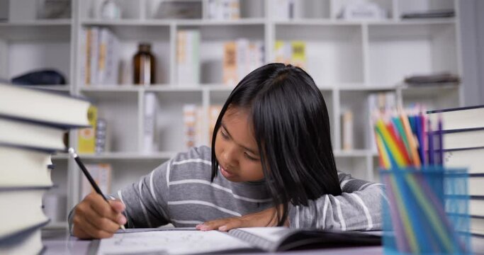 Asian short hair girl doing homework at the desk