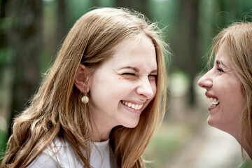 Portrait of two young women smiling, side view