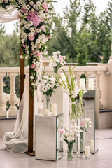 Wedding ceremony. Very beautiful and stylish wedding arch, decorated with various fresh flowers and mirror accesories. Close up.